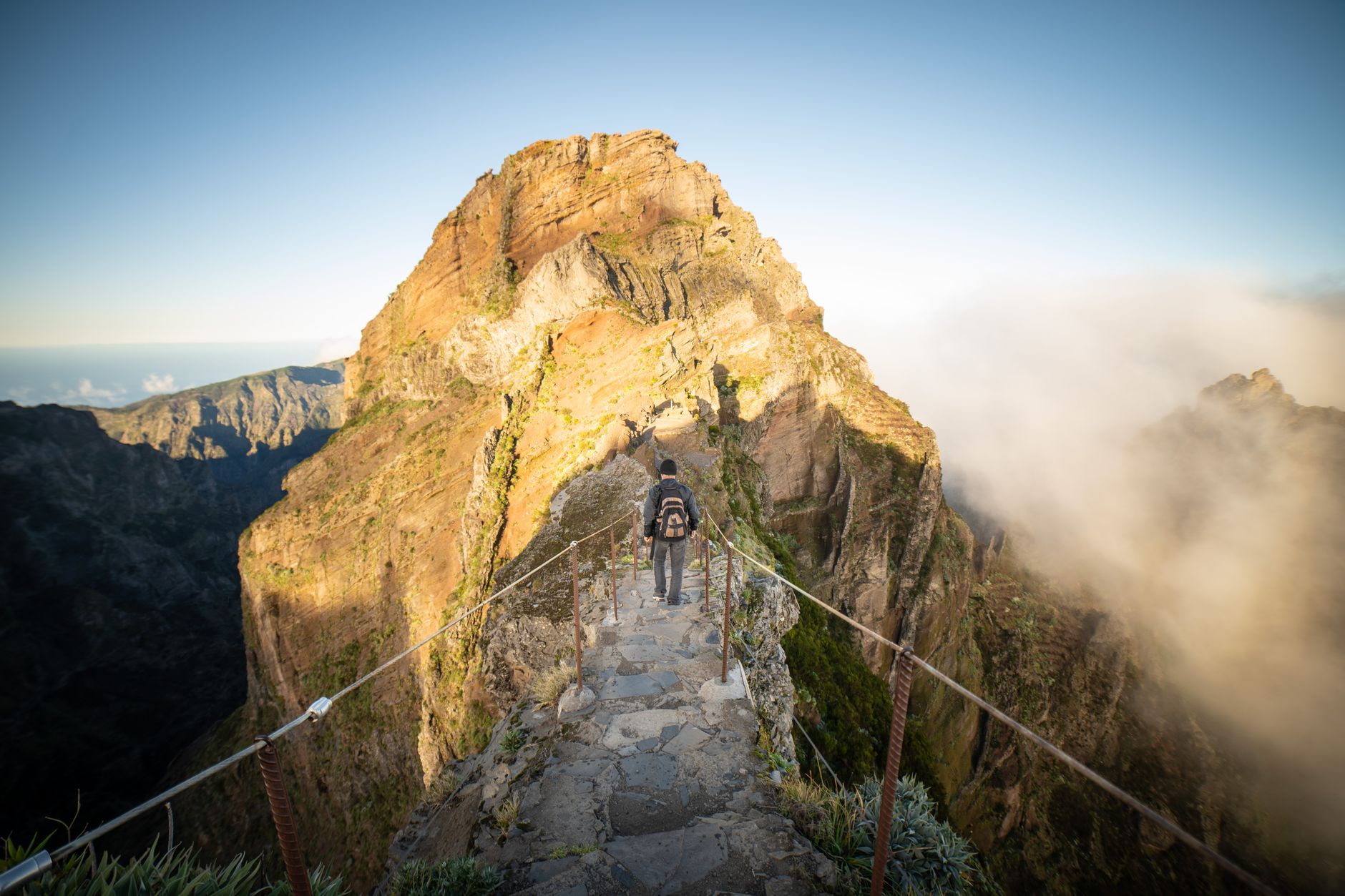 Hiker observing mist over scenic ridges